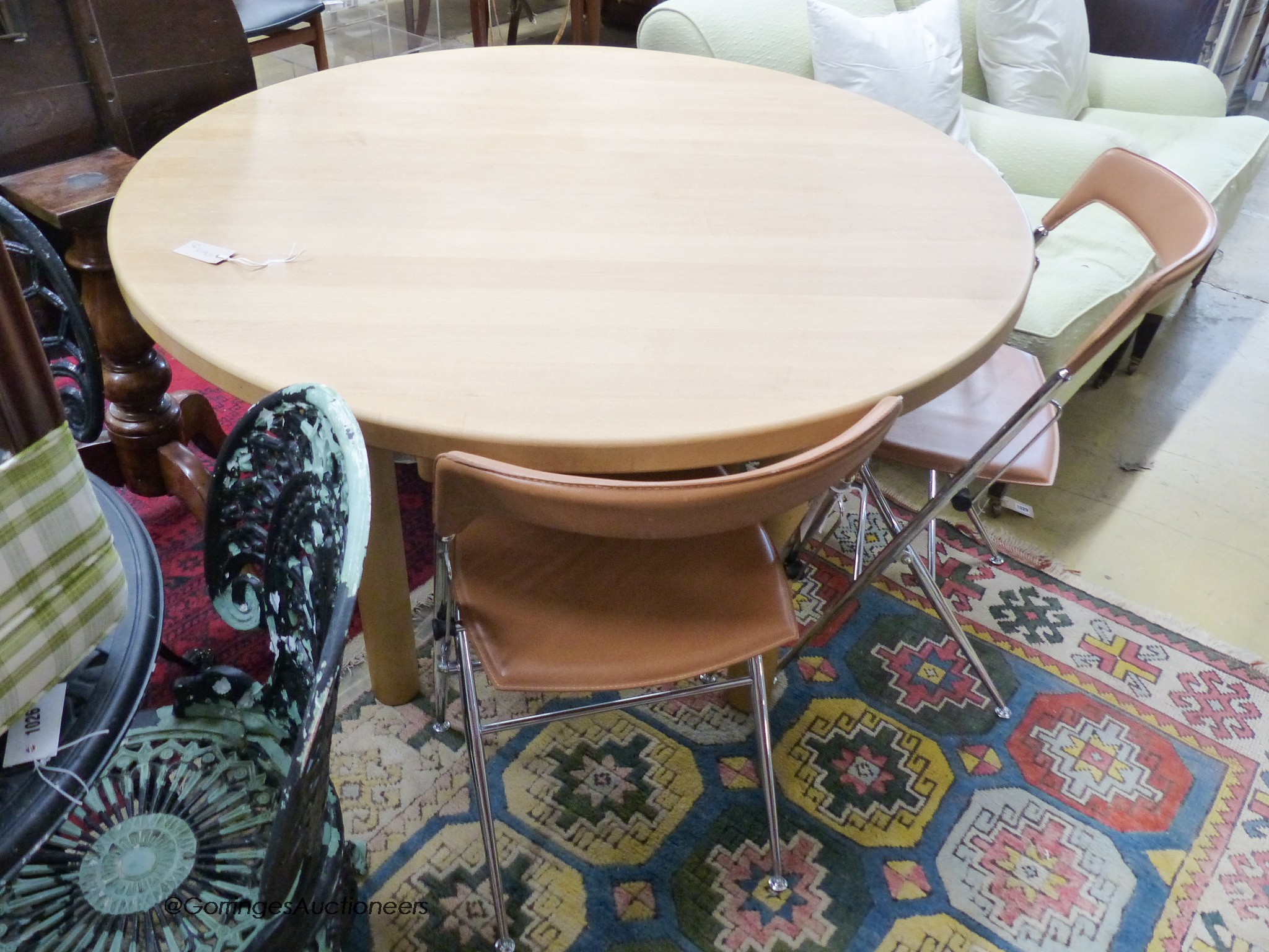 A circular beech breakfast table, depth 122cm, and two Italian chrome chairs.